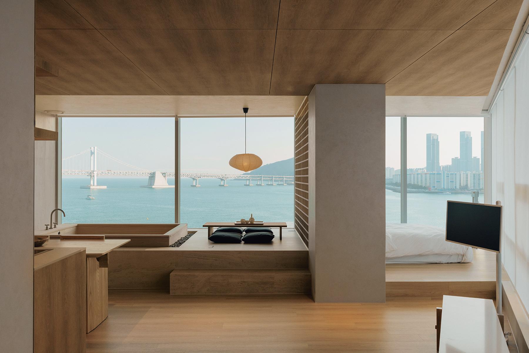 Warm minimalist room interior at ONUJI STAY with ocean view